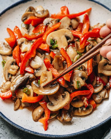 Use chopsticks to lift mushroom and pepper from a plate