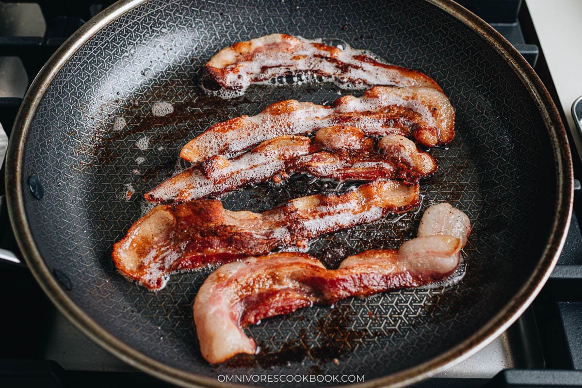cooking the bacon on a skillet