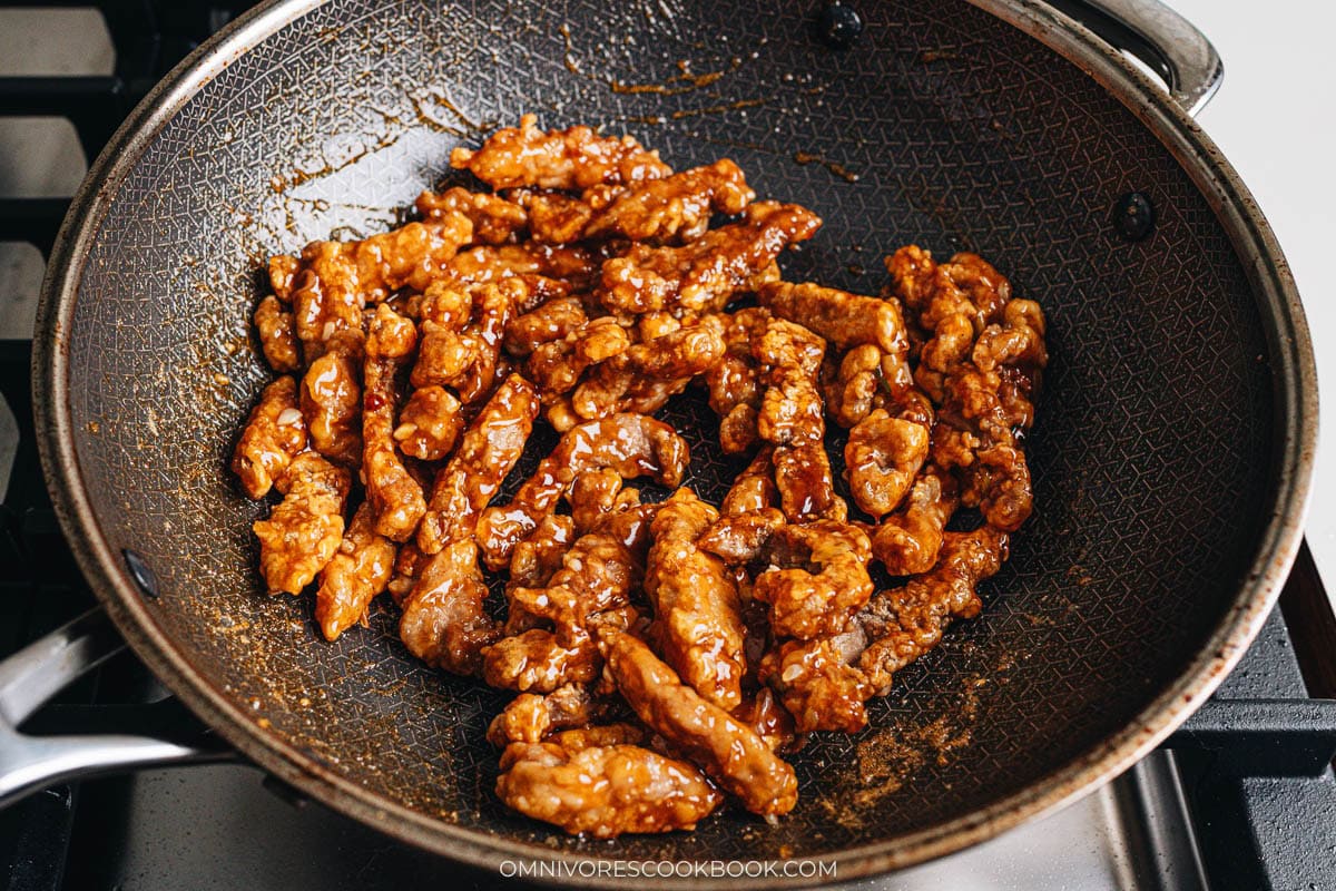 Tossing the pork in the sauce